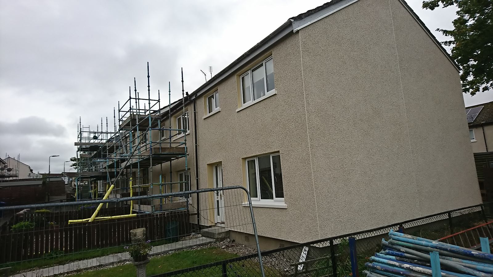 scaffolded side under roughcast render repair Edinburgh