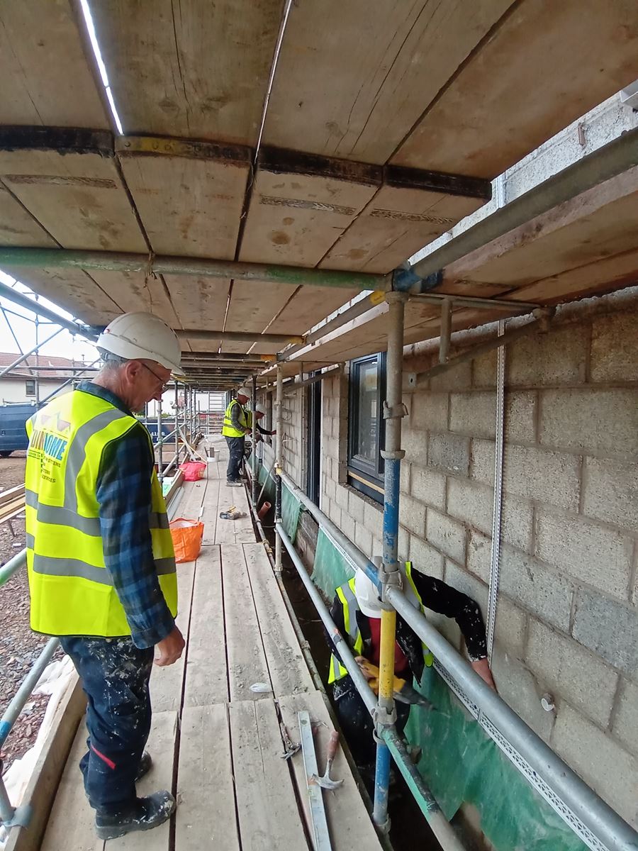 roughcast render applied to the exterior of the building with visible details