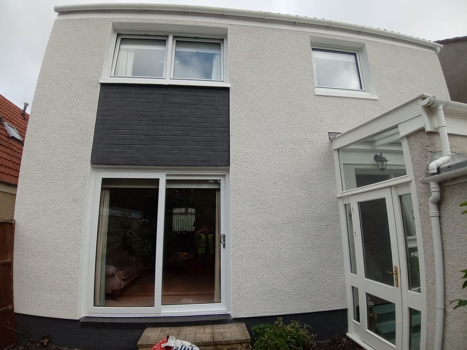 roughcast render Edinburgh applied to the side of a house near a window