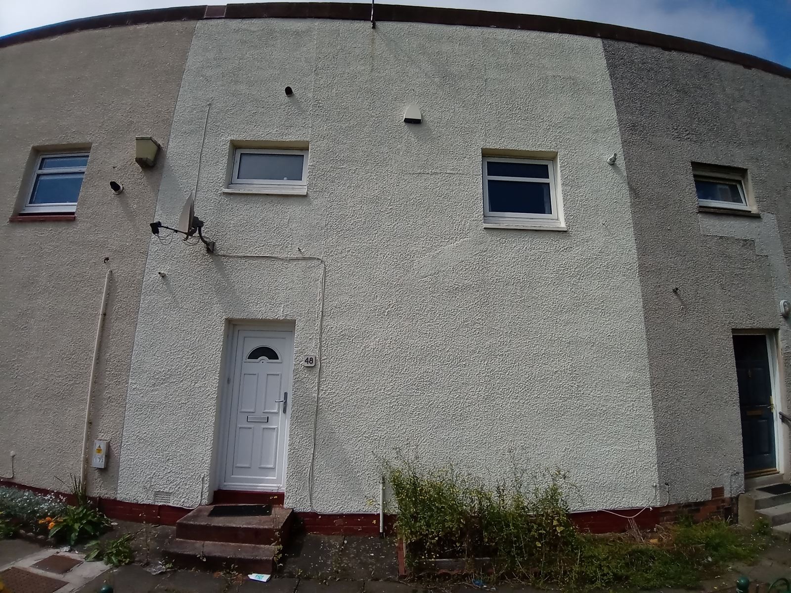 roughcast render applied to the exterior of a house near the entrance