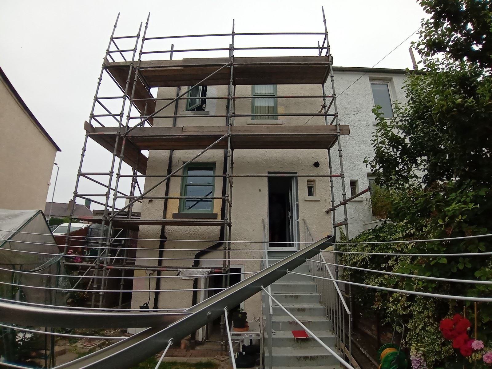 roughcast render repair on the exterior wall with peeling plaster