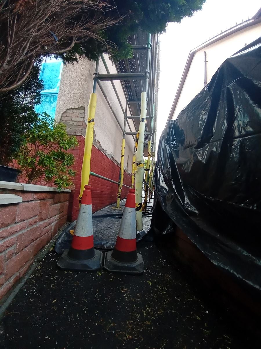 roughcast render Edinburgh applied near the entrance with cones visible