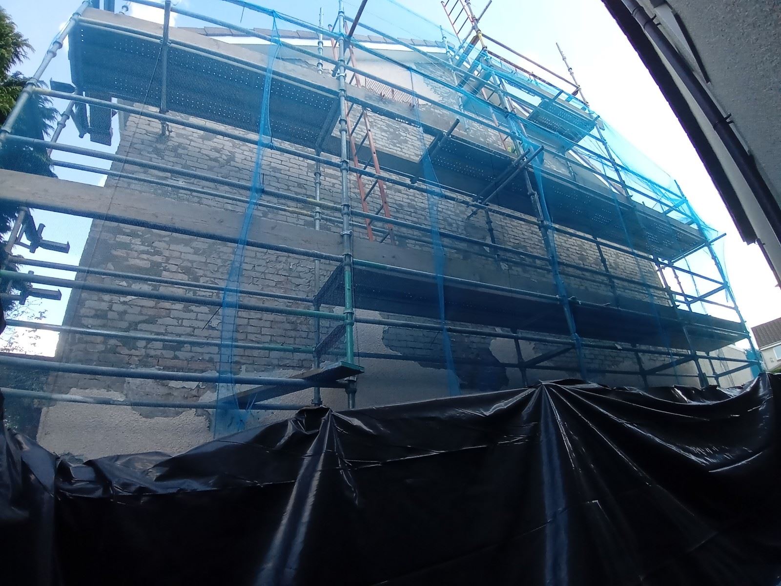 roughcast render Edinburgh applied to a wall near windows and scaffolding
