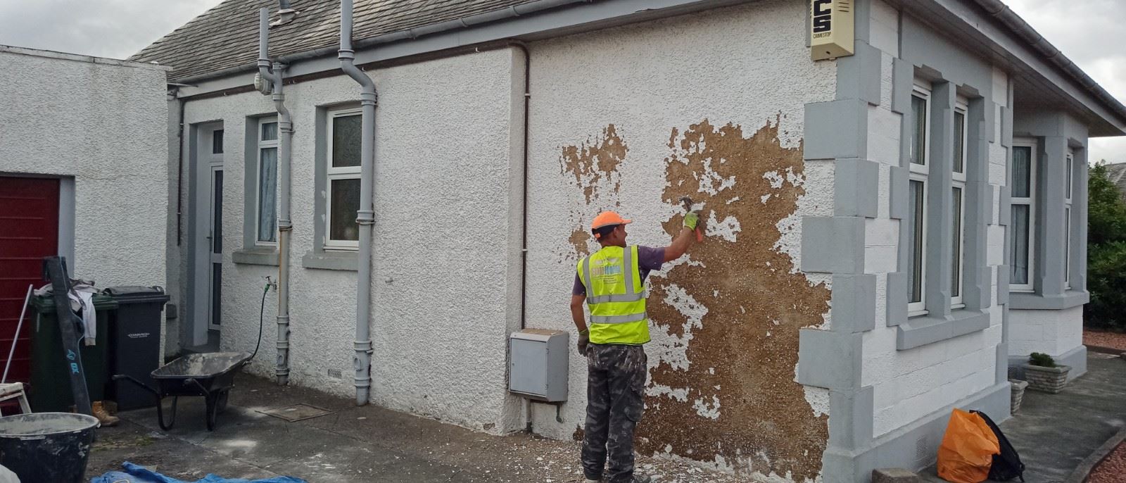 roughcast render repair on the wall with visible damage
