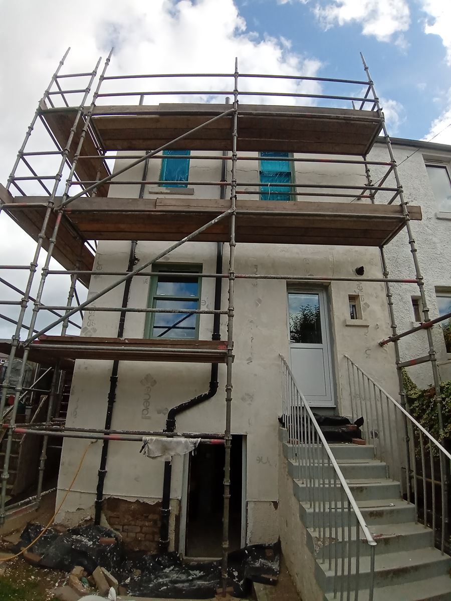 roughcast render Edinburgh near a window and door on the exterior wall