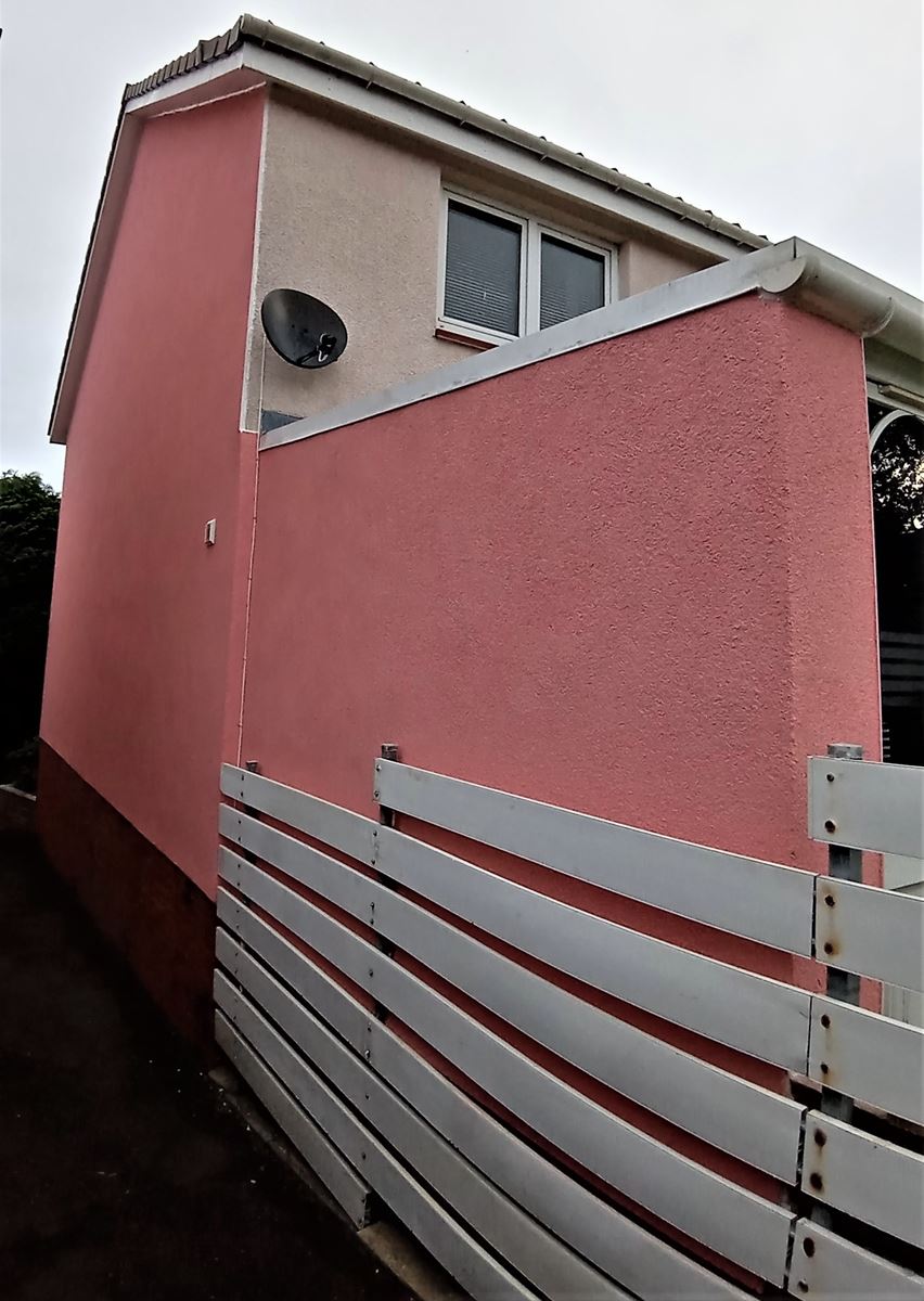 roughcast render Edinburgh applied to the side of the house near the fence