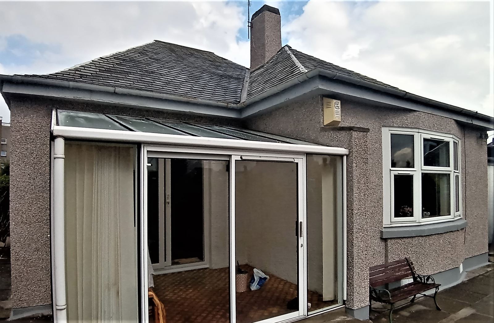 roughcast render Edinburgh applied to the side of the house near the roof