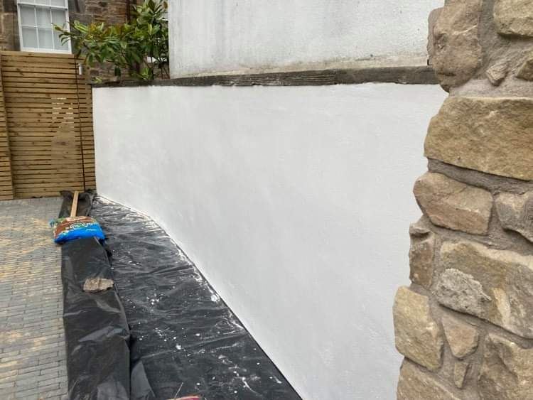rendering Edinburgh on the exterior wall near a stone feature