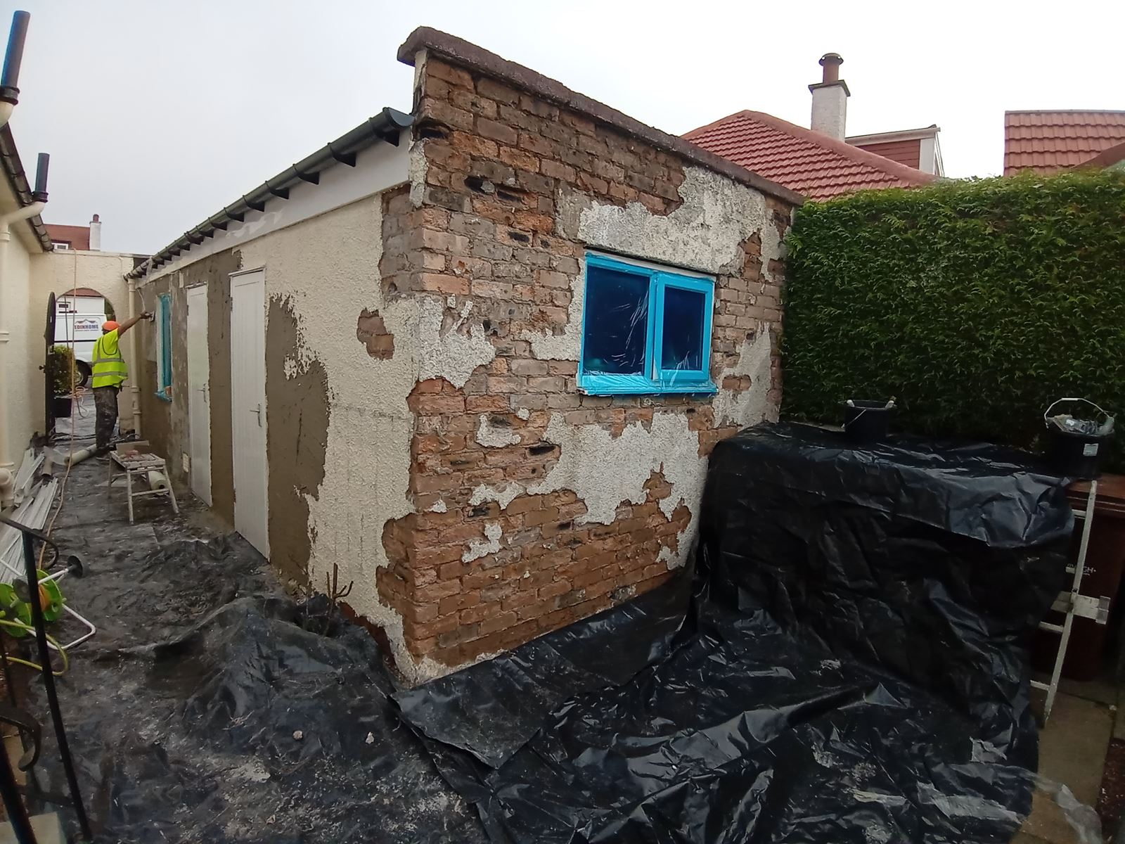 roughcast render repair near a window during construction