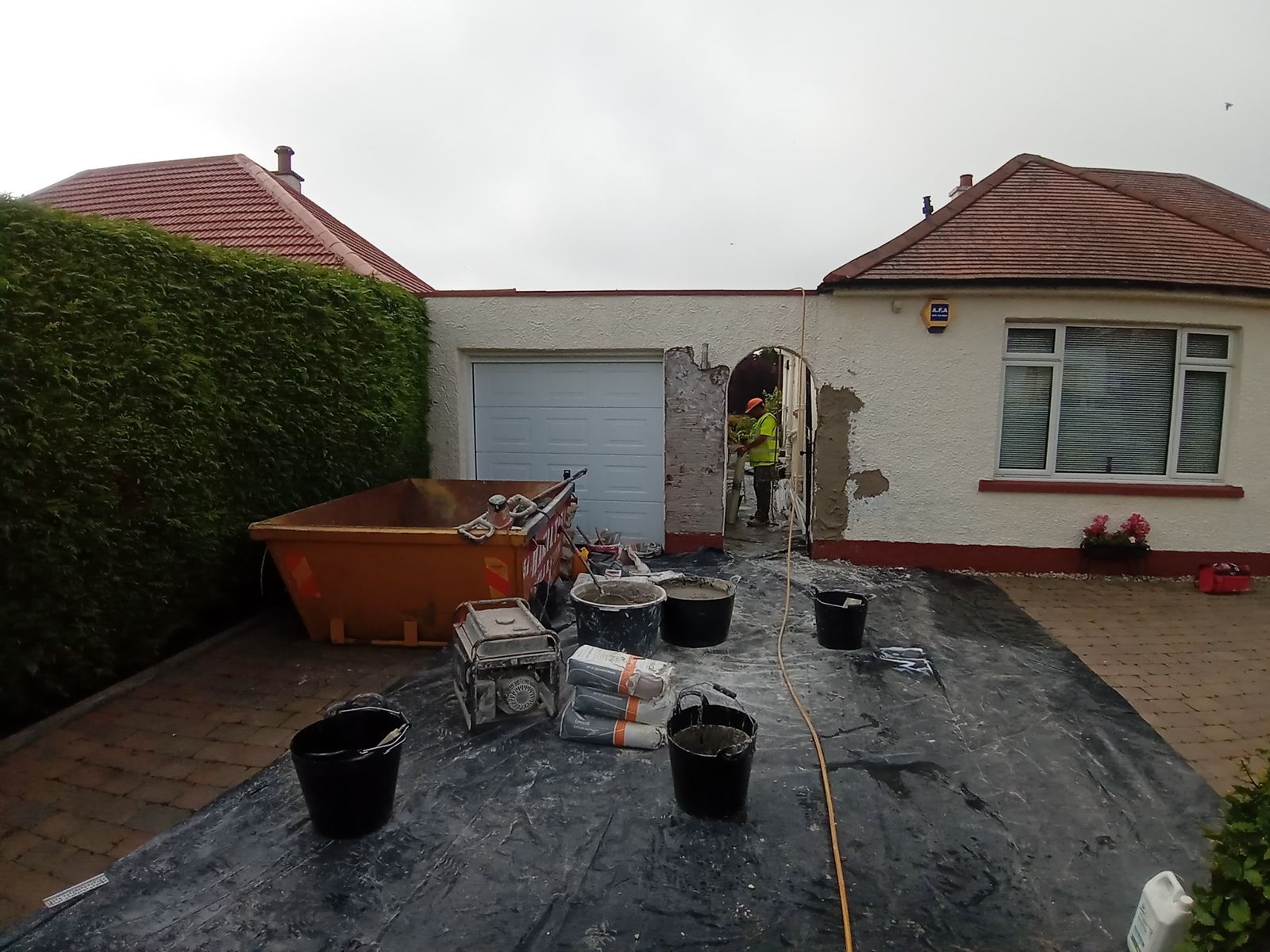 rendering Edinburgh applied to the exterior wall with tools in use