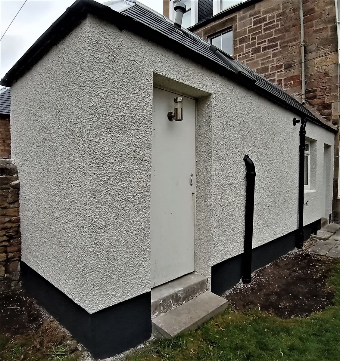 roughcast render Edinburgh applied to a house exterior corner