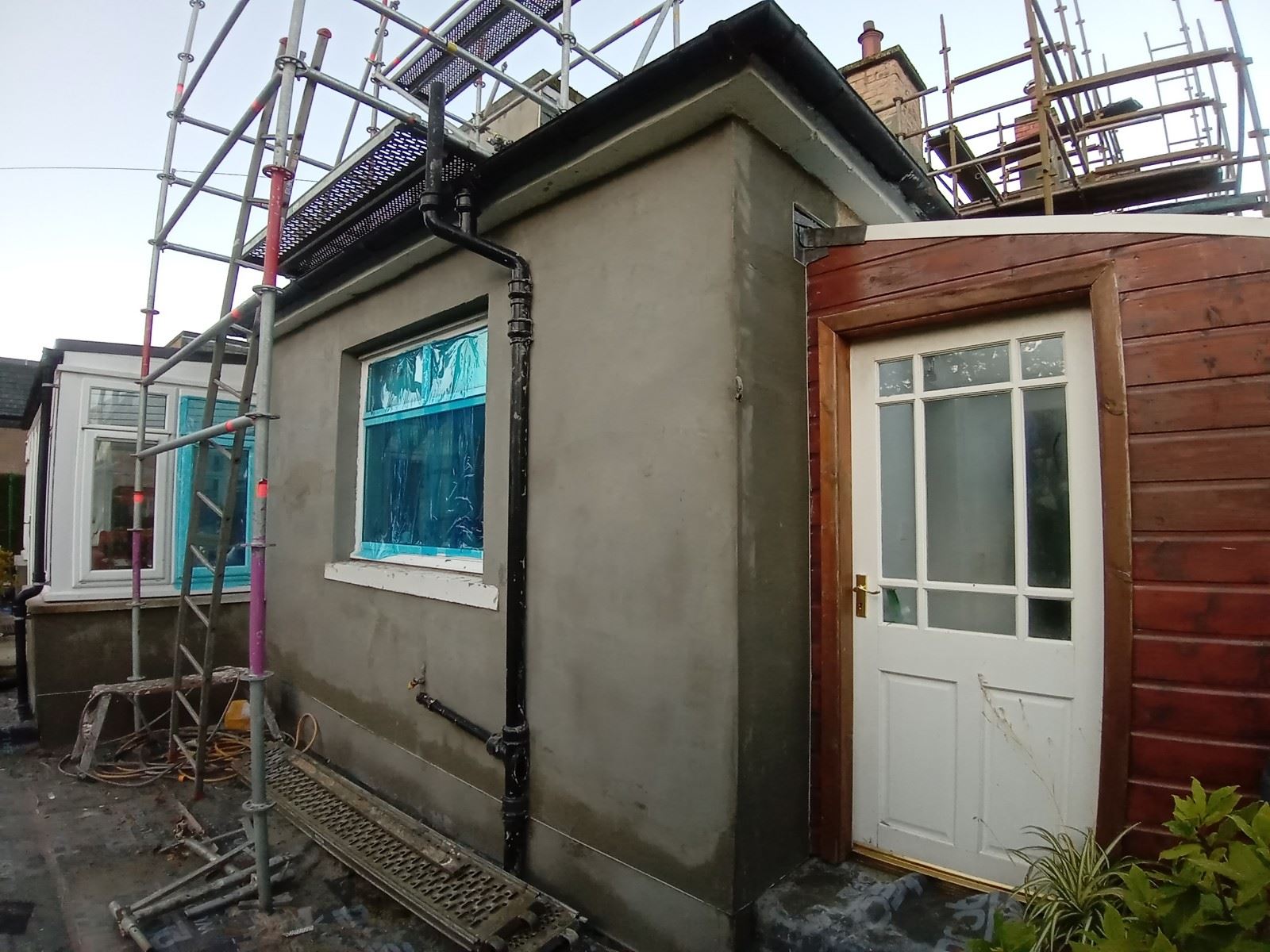 roughcast render repair around windows on the exterior wall