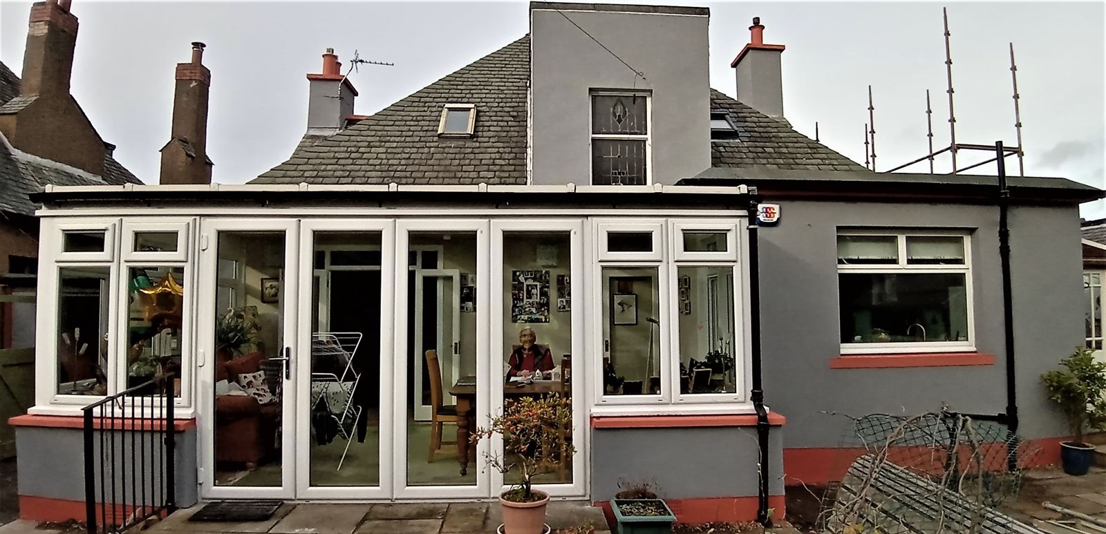 house rendering Edinburgh around windows with red accents