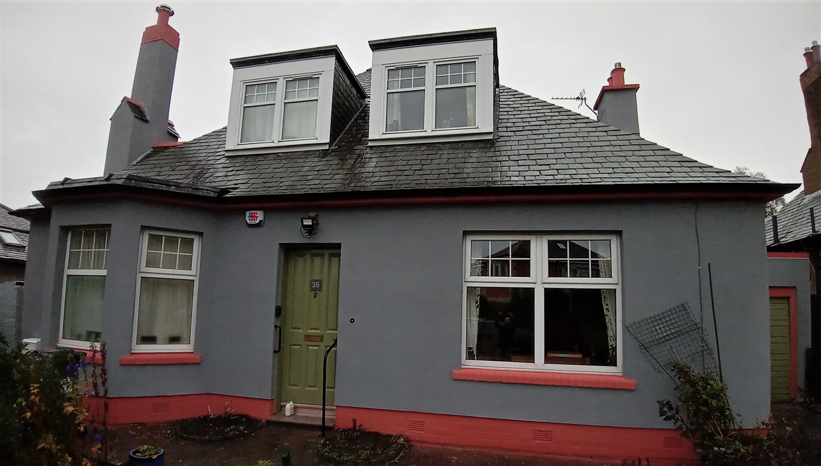 roughcast render Edinburgh applied to a house with red accents