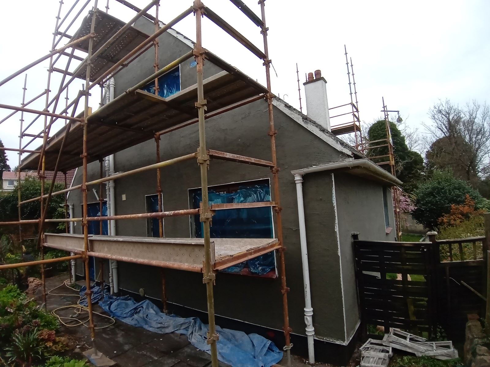 long scaffolded wall in house rendering edinburgh