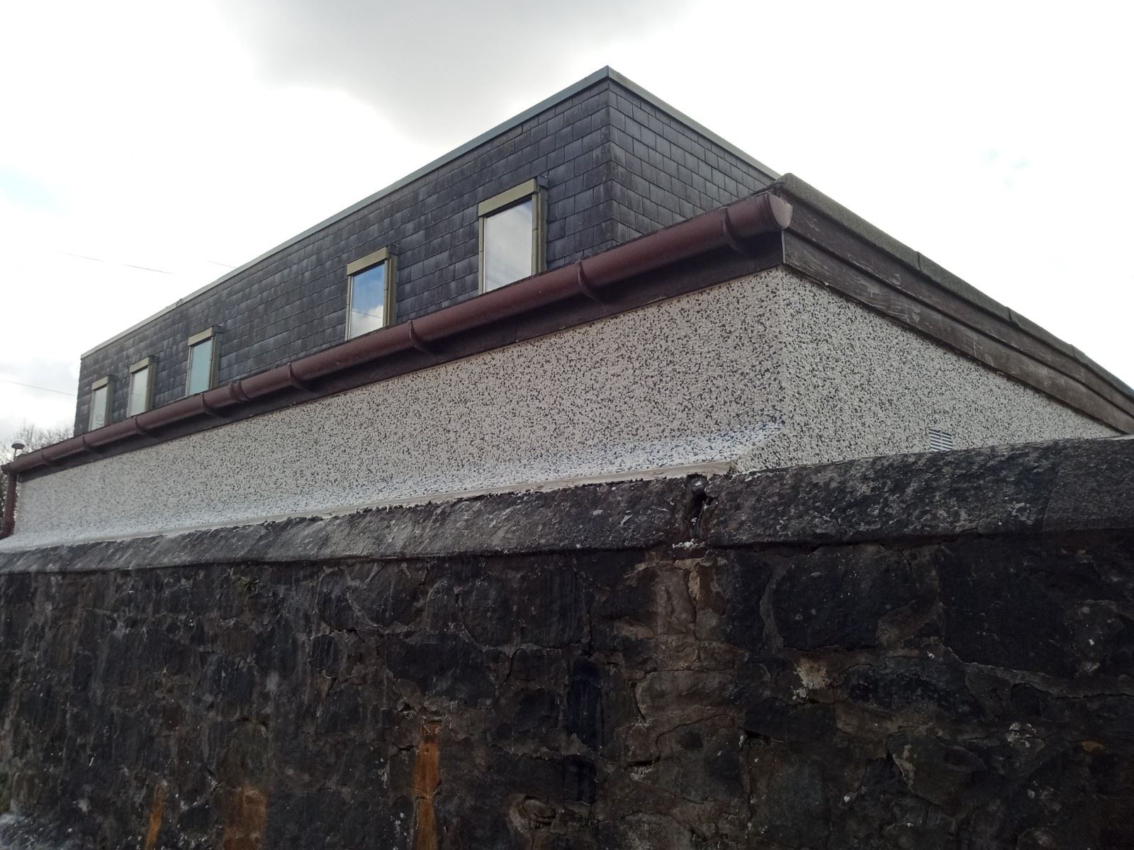 raised gable above roughcast repair