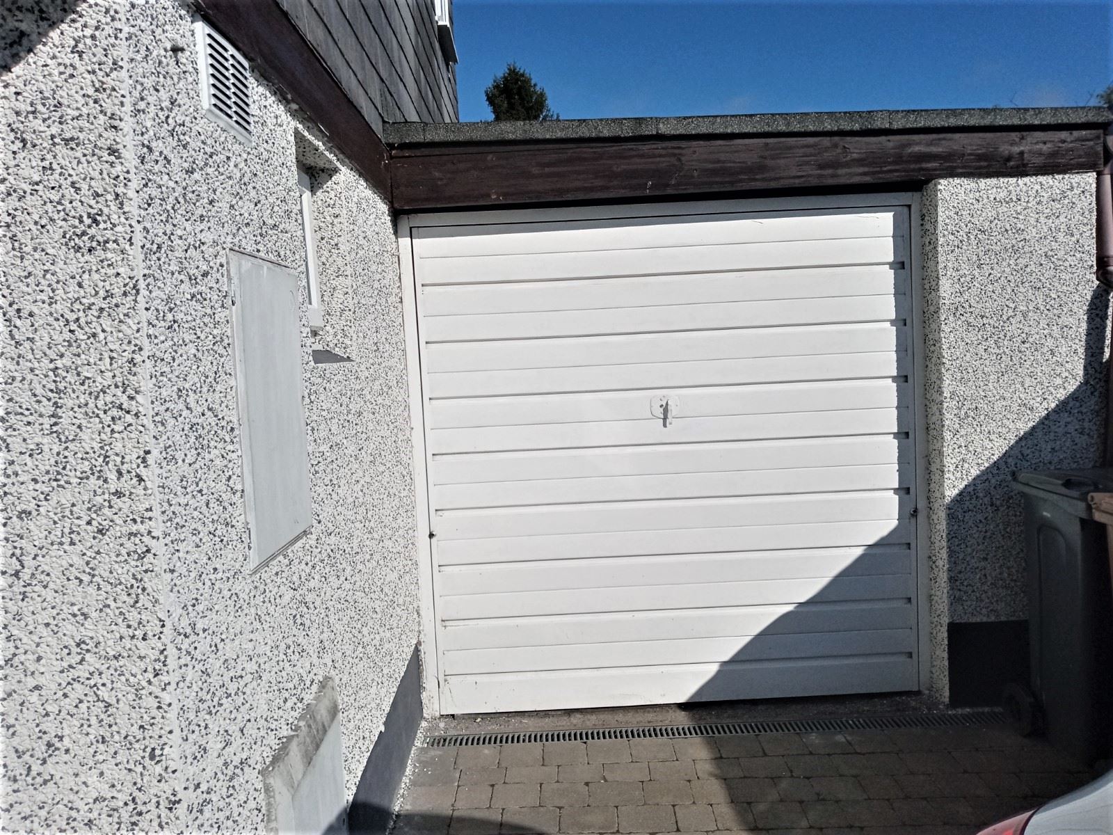 garage front detailed by roughcast render repair