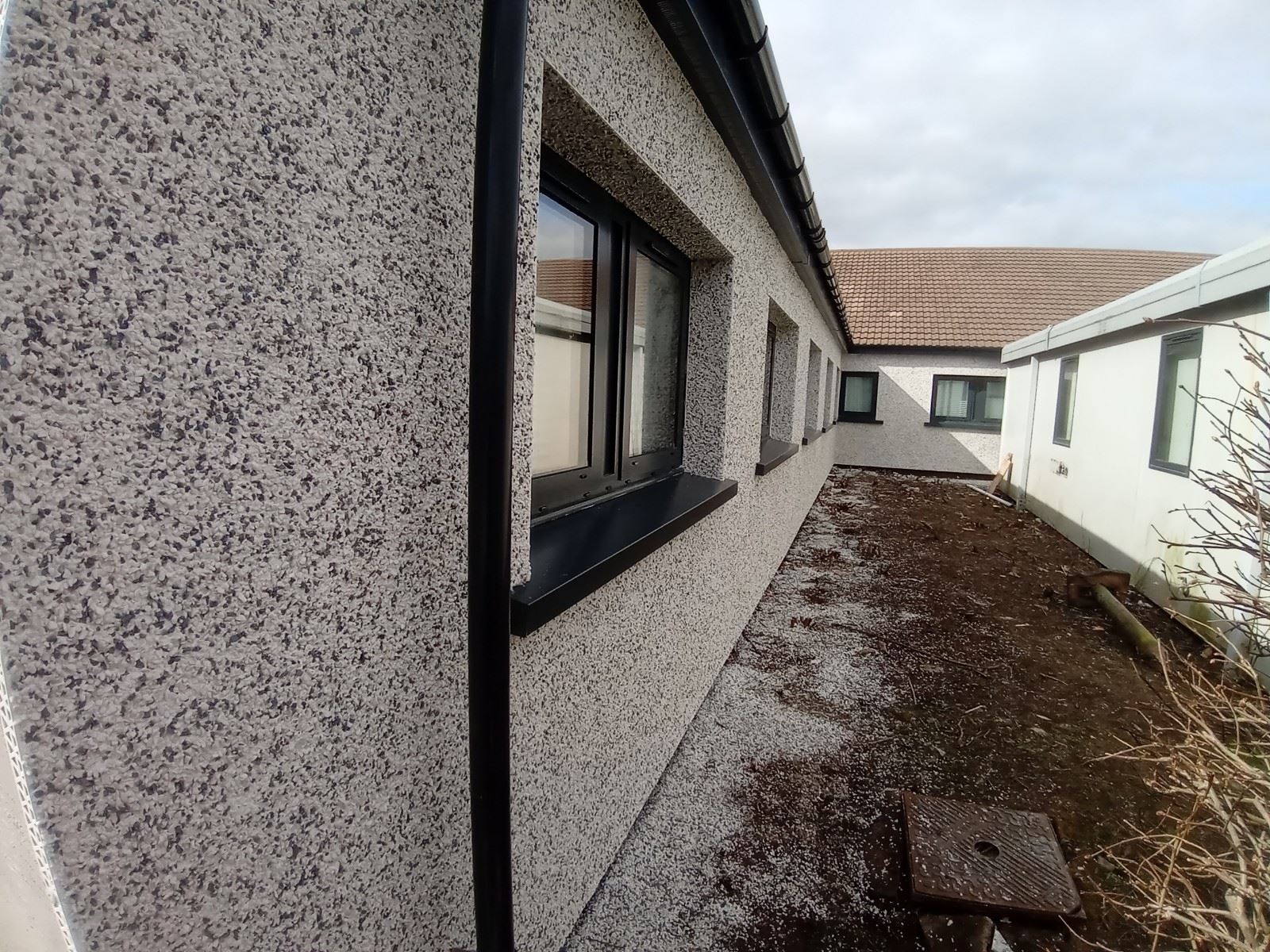 close wall finish showing roughcast repair