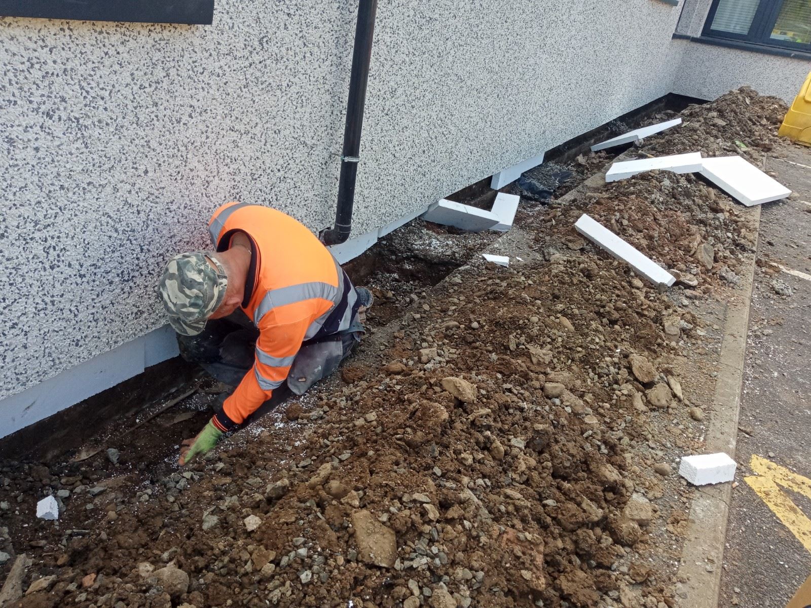 worker digging near house rendering edinburgh