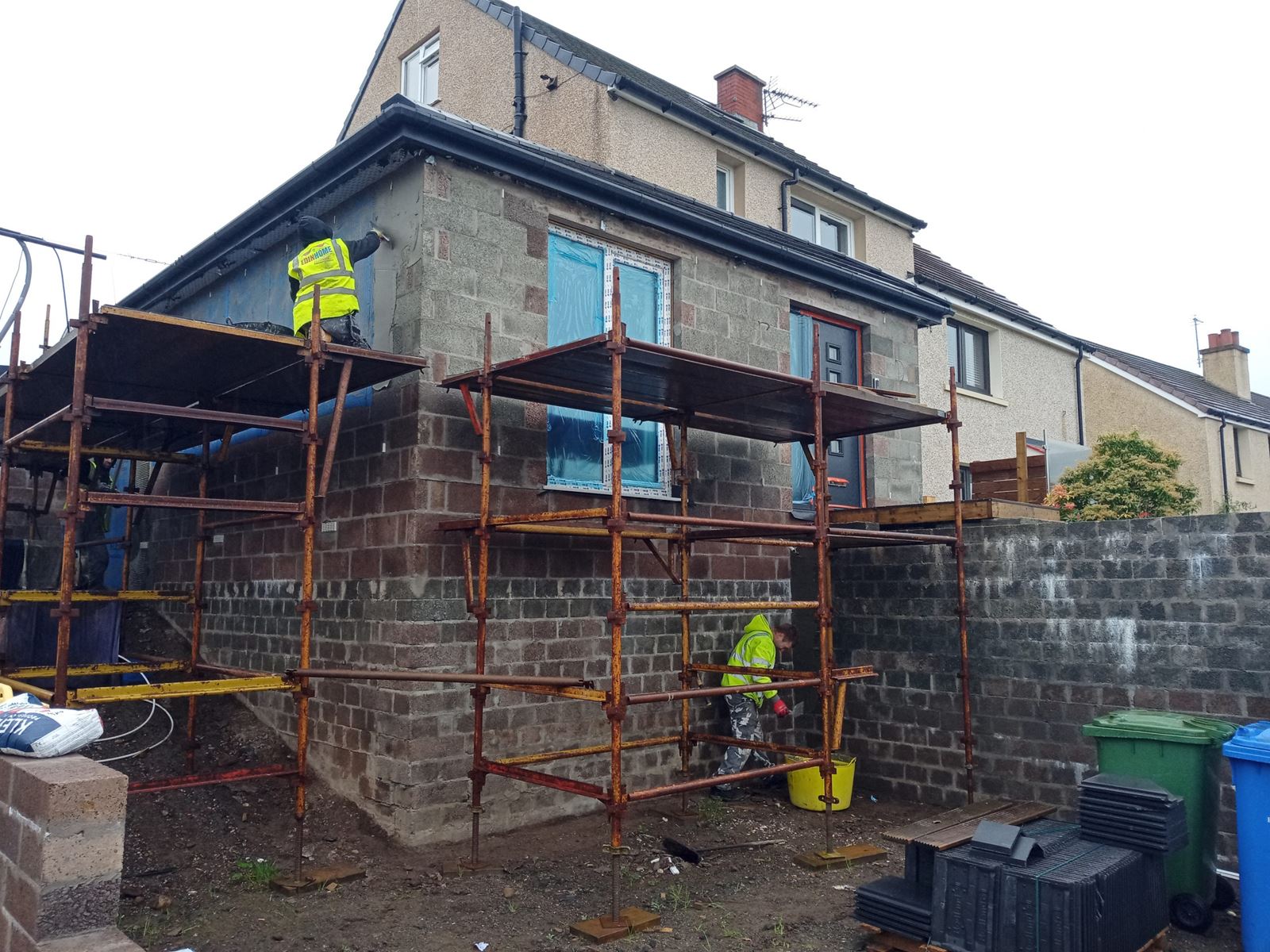 roughcast render Edinburgh on rear wall with scaffolding and workers