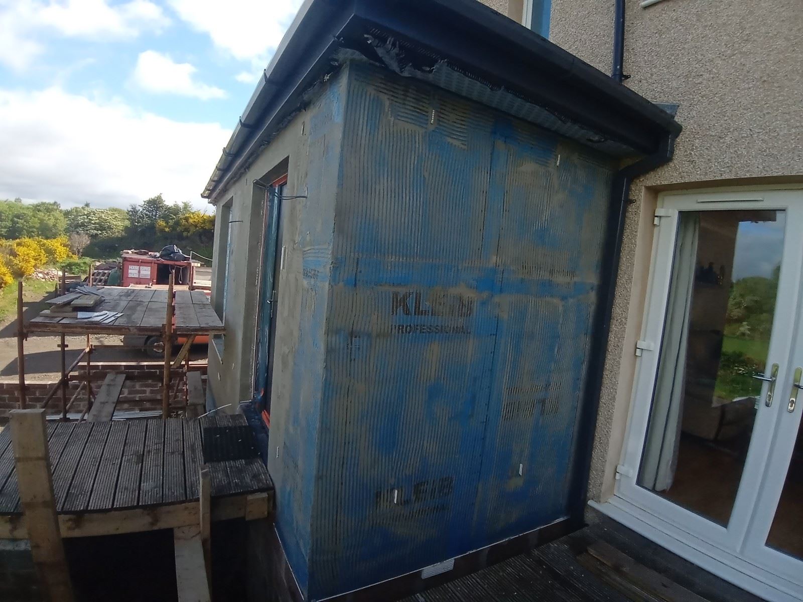 solid wall insulation Edinburgh on extension wall secured with blue film