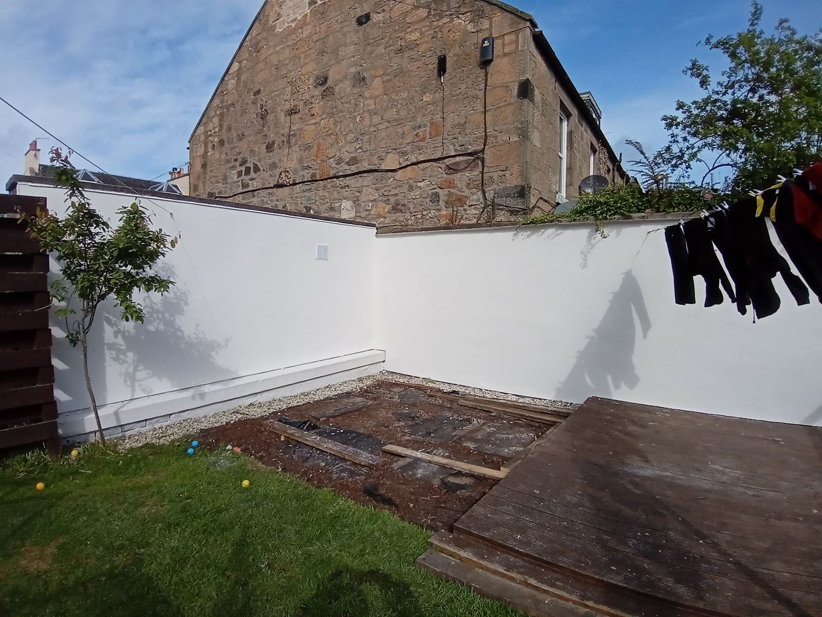 roughcasting Edinburgh on bright white garden boundary wall