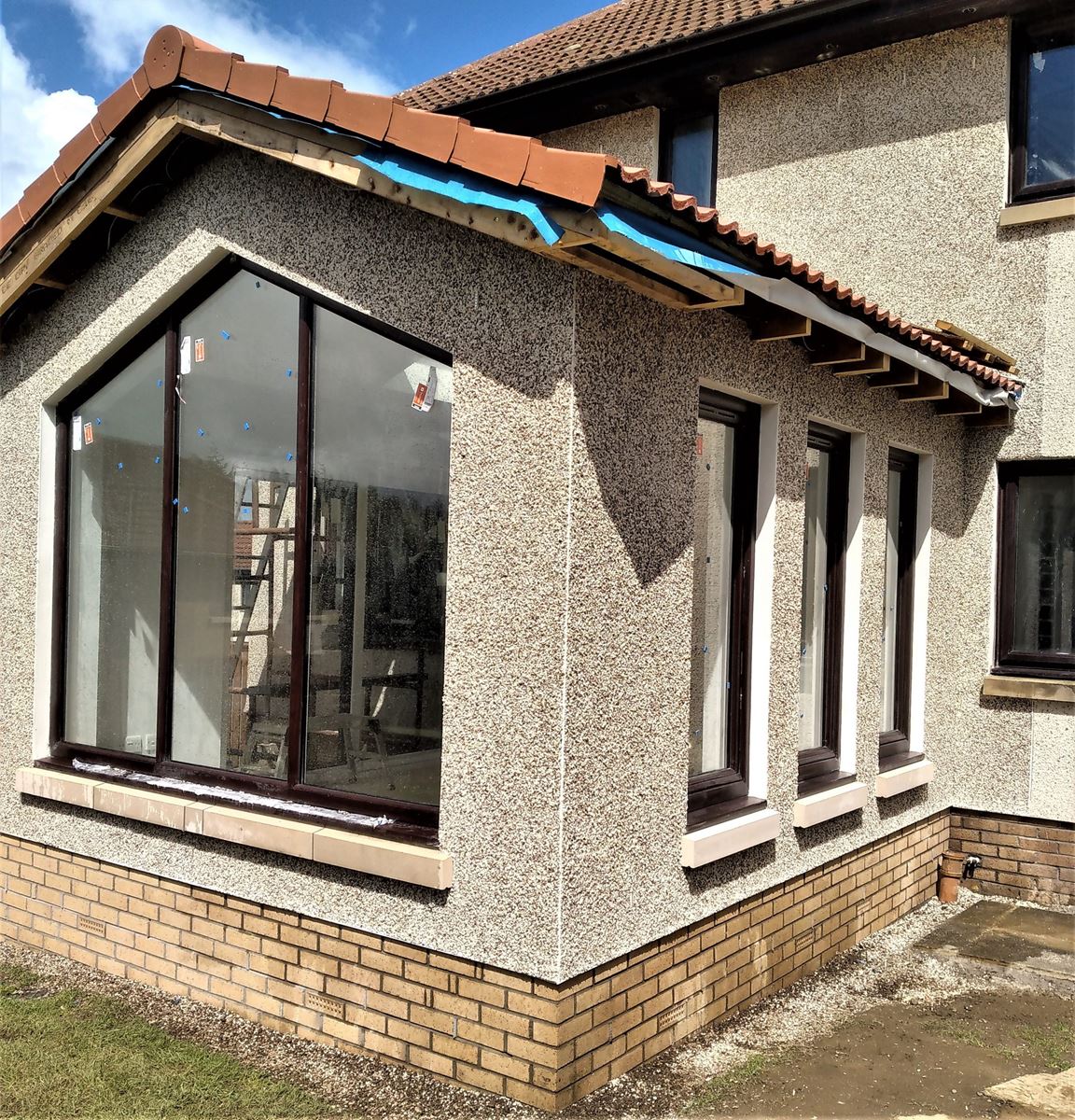 roughcaster Edinburgh applying render on gable extension with large window