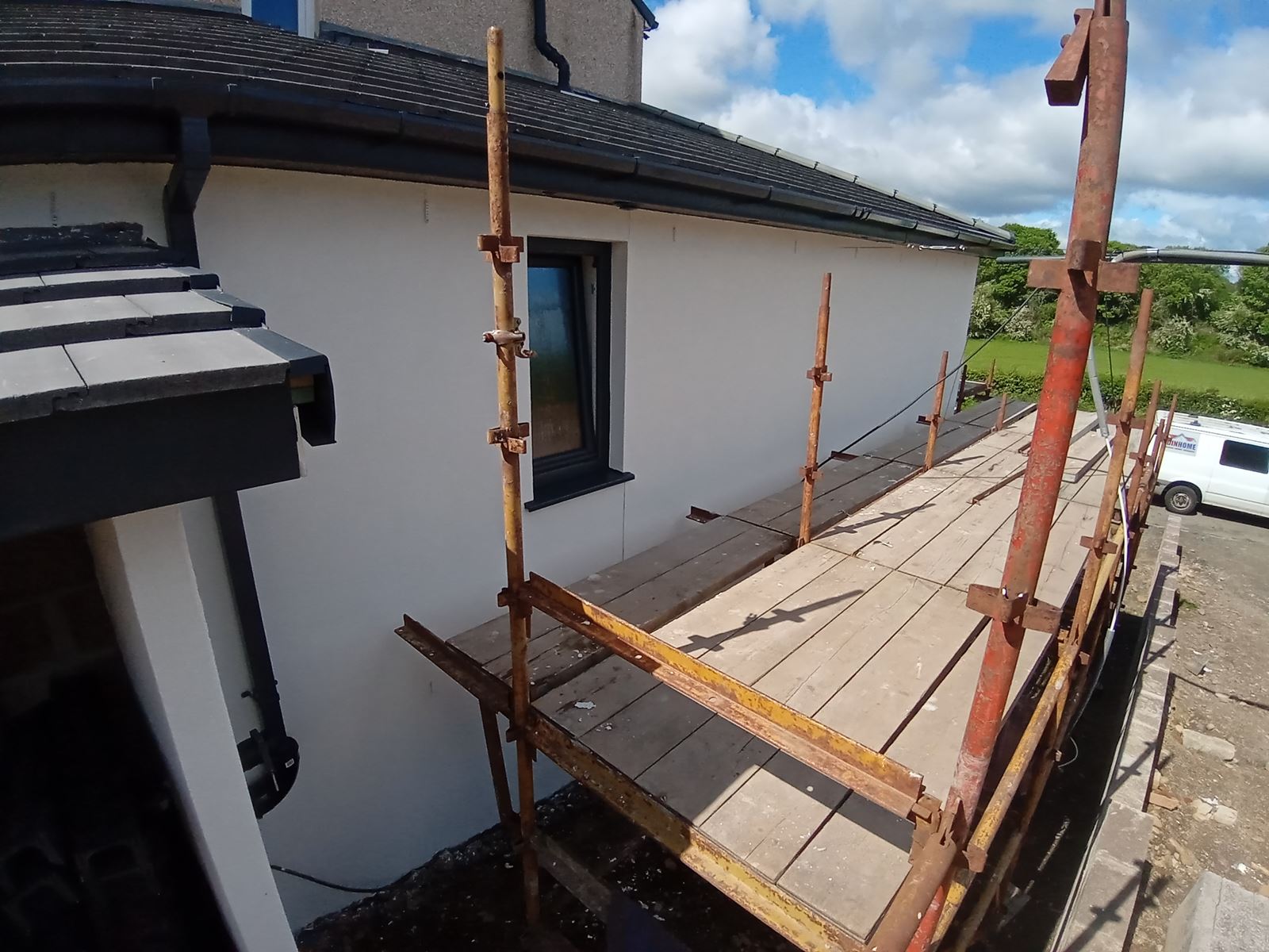 roughcast render Edinburgh on side elevation under timber scaffold