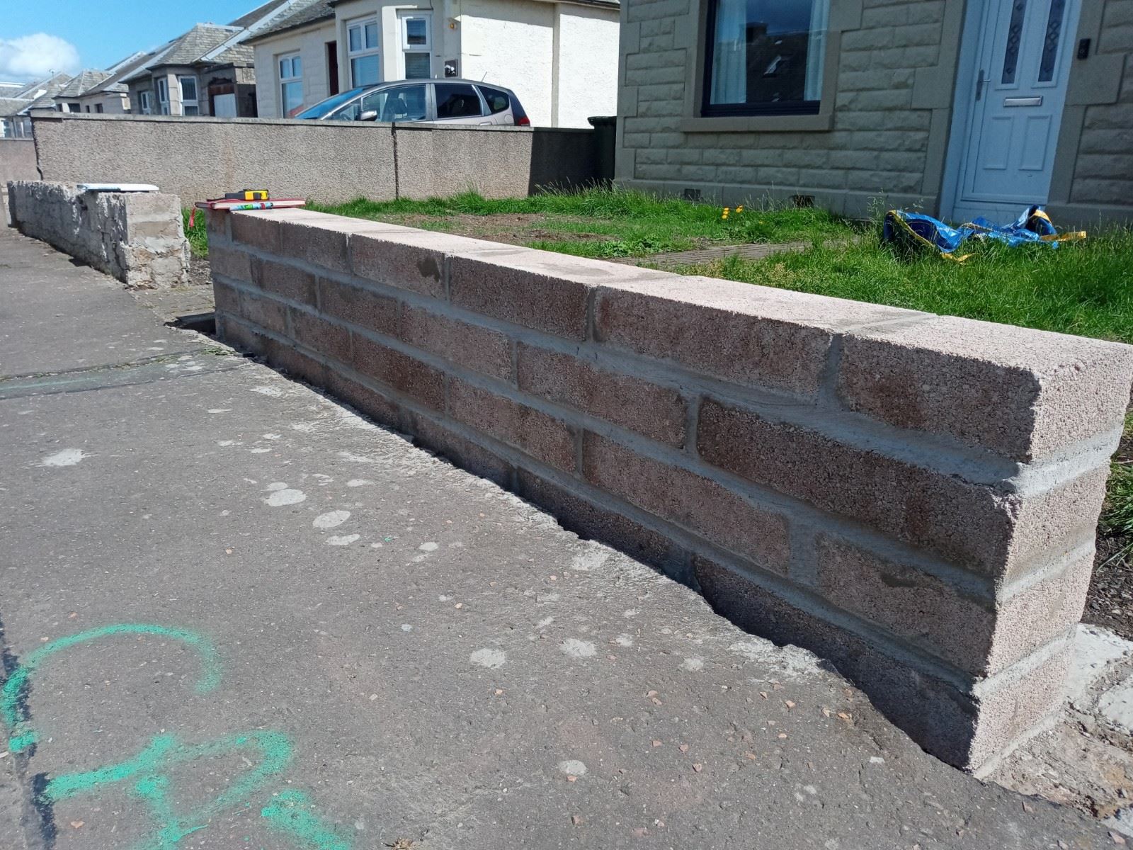 roughcaster Edinburgh preparing new brick boundary wall section