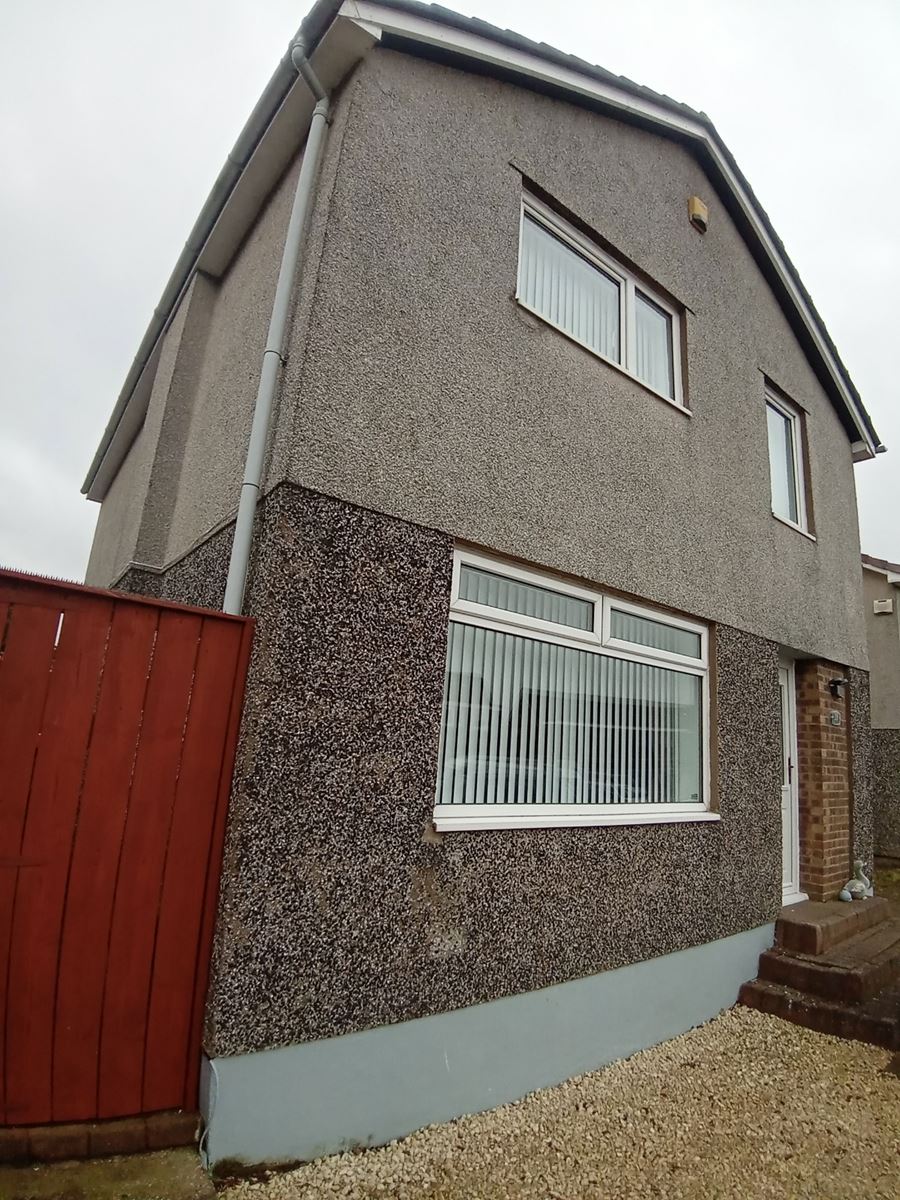house rendering Edinburgh on side wall beside red wooden fence