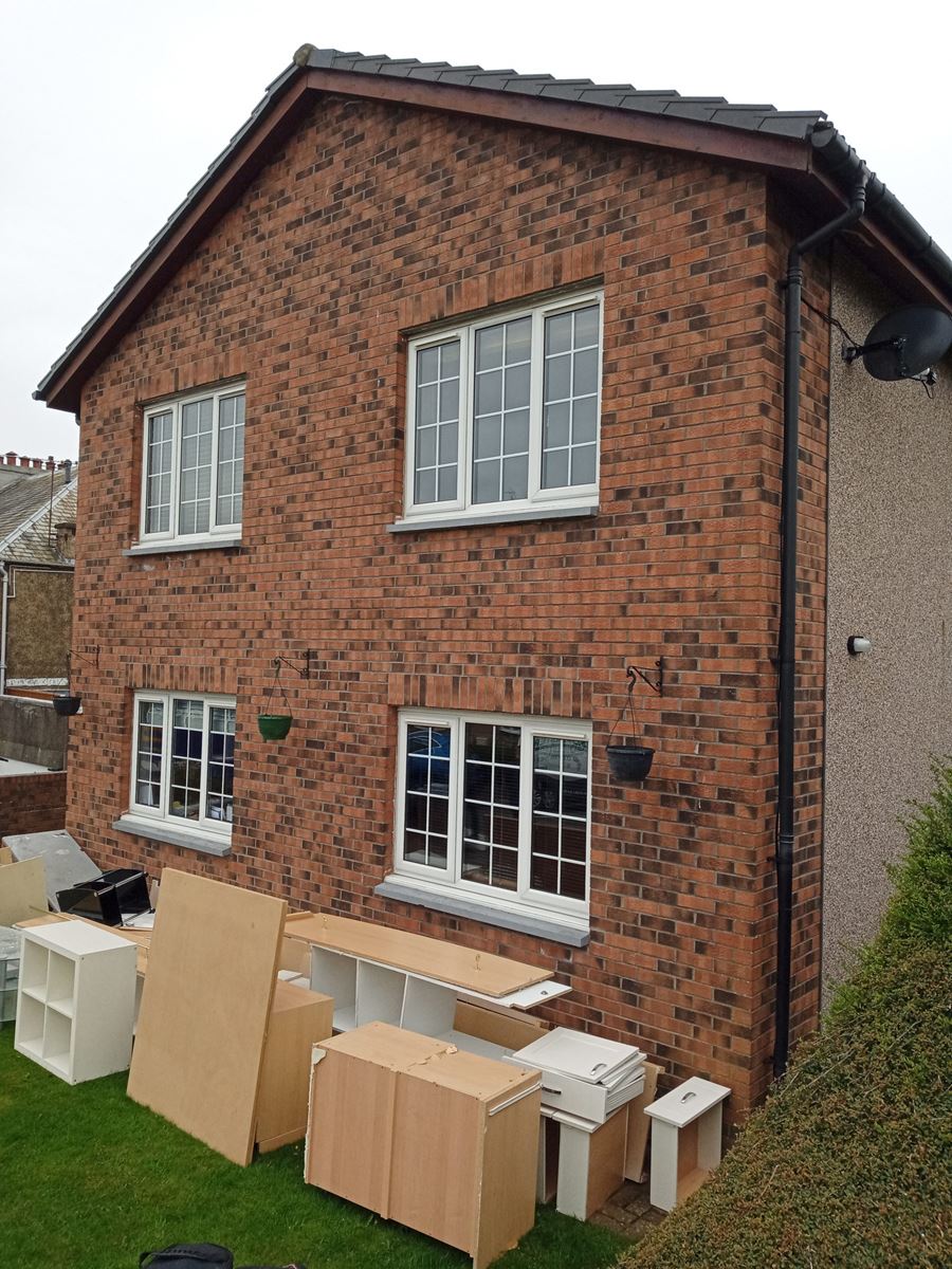 roughcasting Edinburgh on front brick façade with white-framed windows
