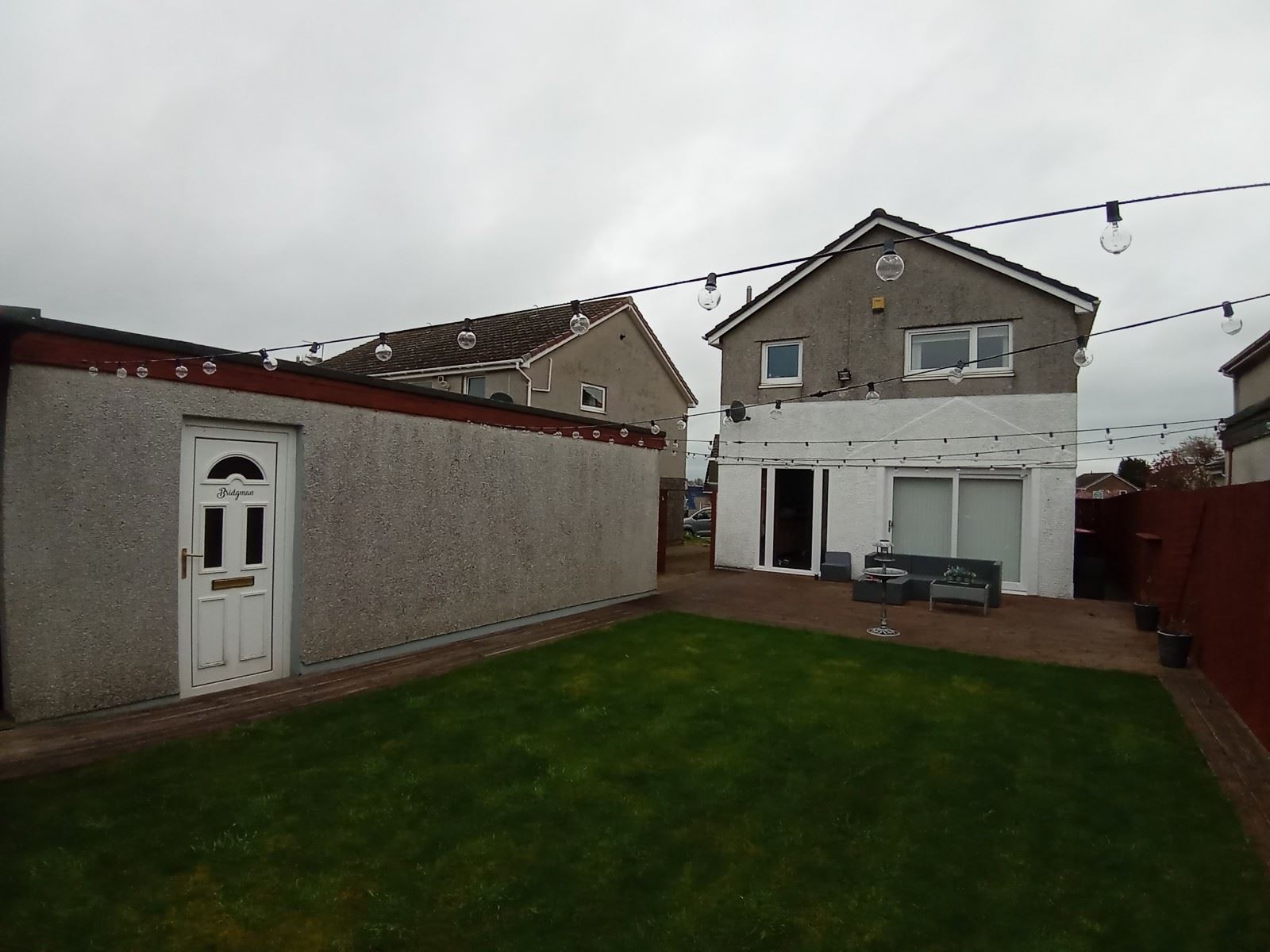 roughcaster Edinburgh working on rear wall near garden