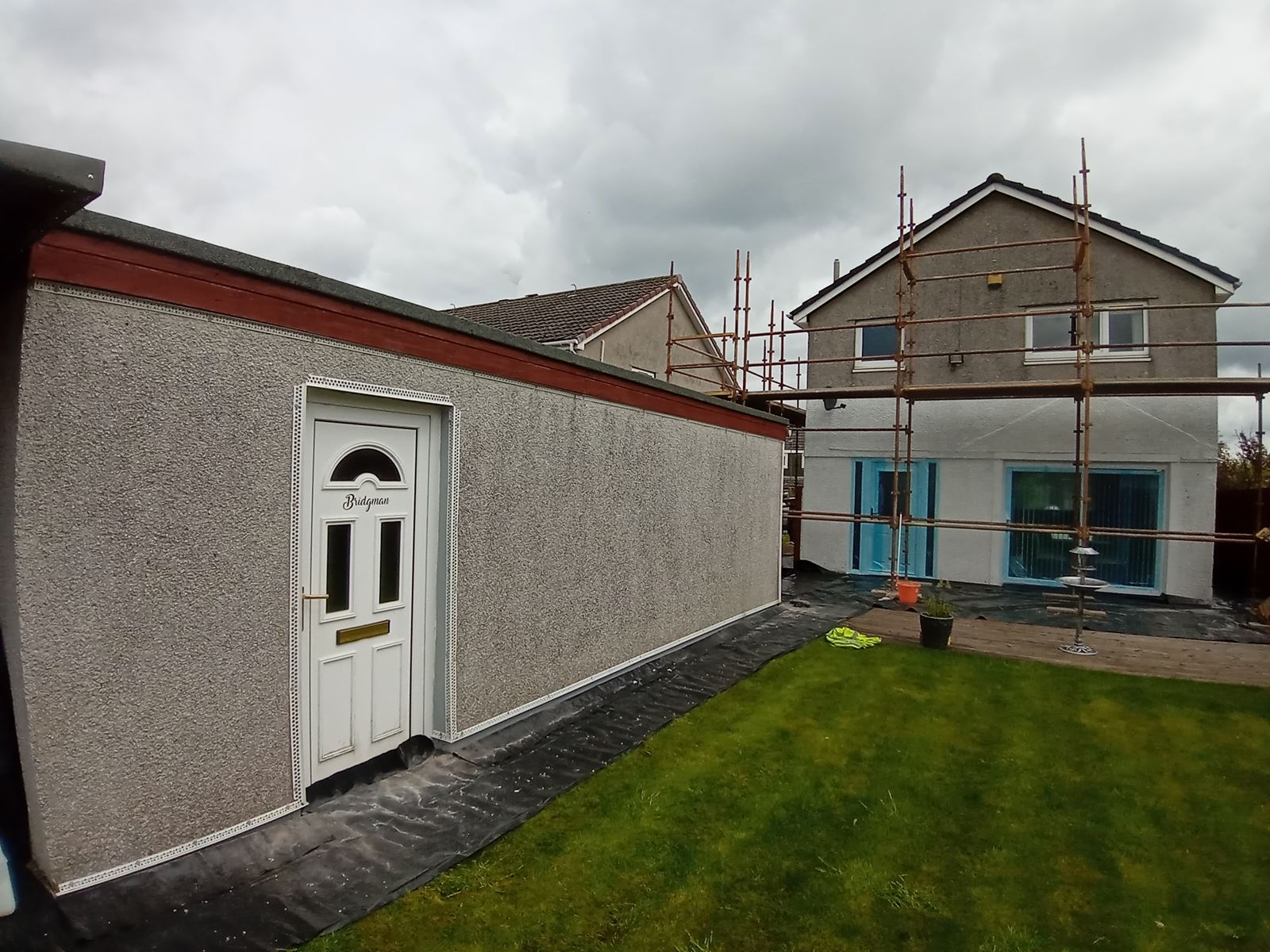 roughcast render Edinburgh on rear house elevation with white door