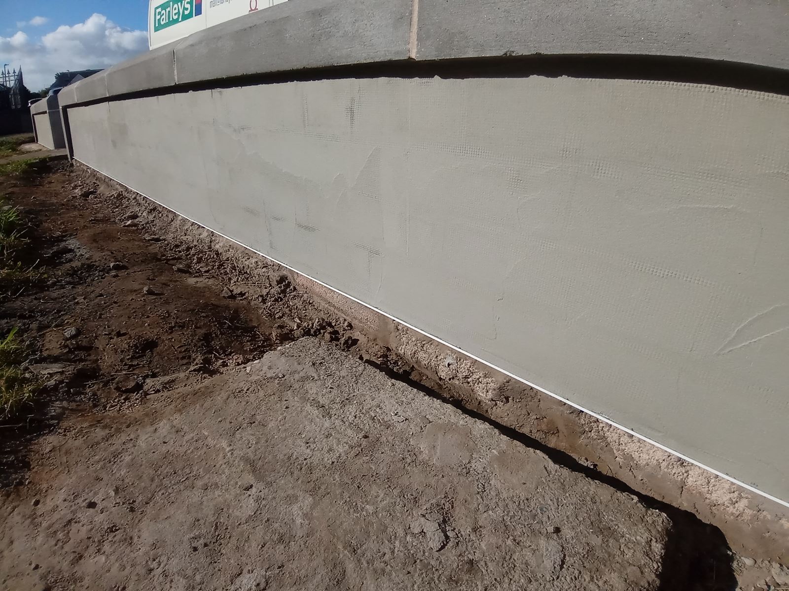 Rendering Edinburgh on boundary wall beside metal post