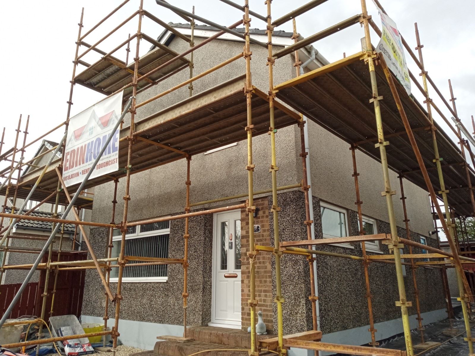 solid wall insulation Edinburgh on front façade with scaffold and entry door