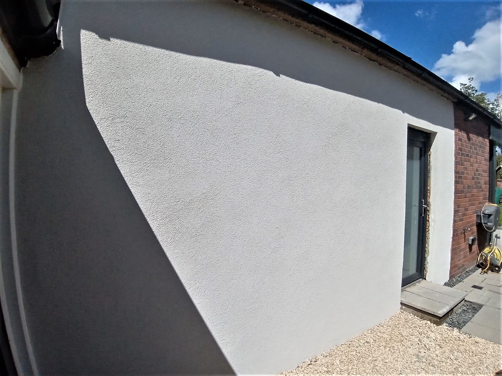 roughcaster Edinburgh applying neat render on side wall