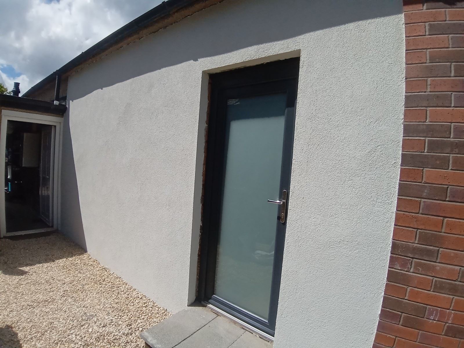 roughcast render Edinburgh on small building with modern door