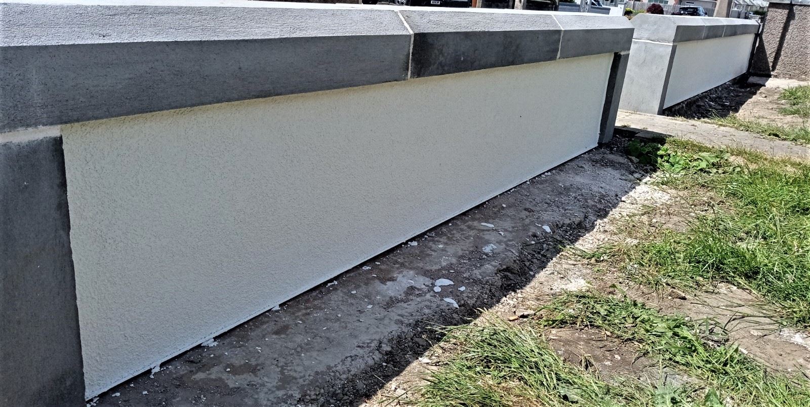 roughcast render repair on finished wall base with smooth white finish