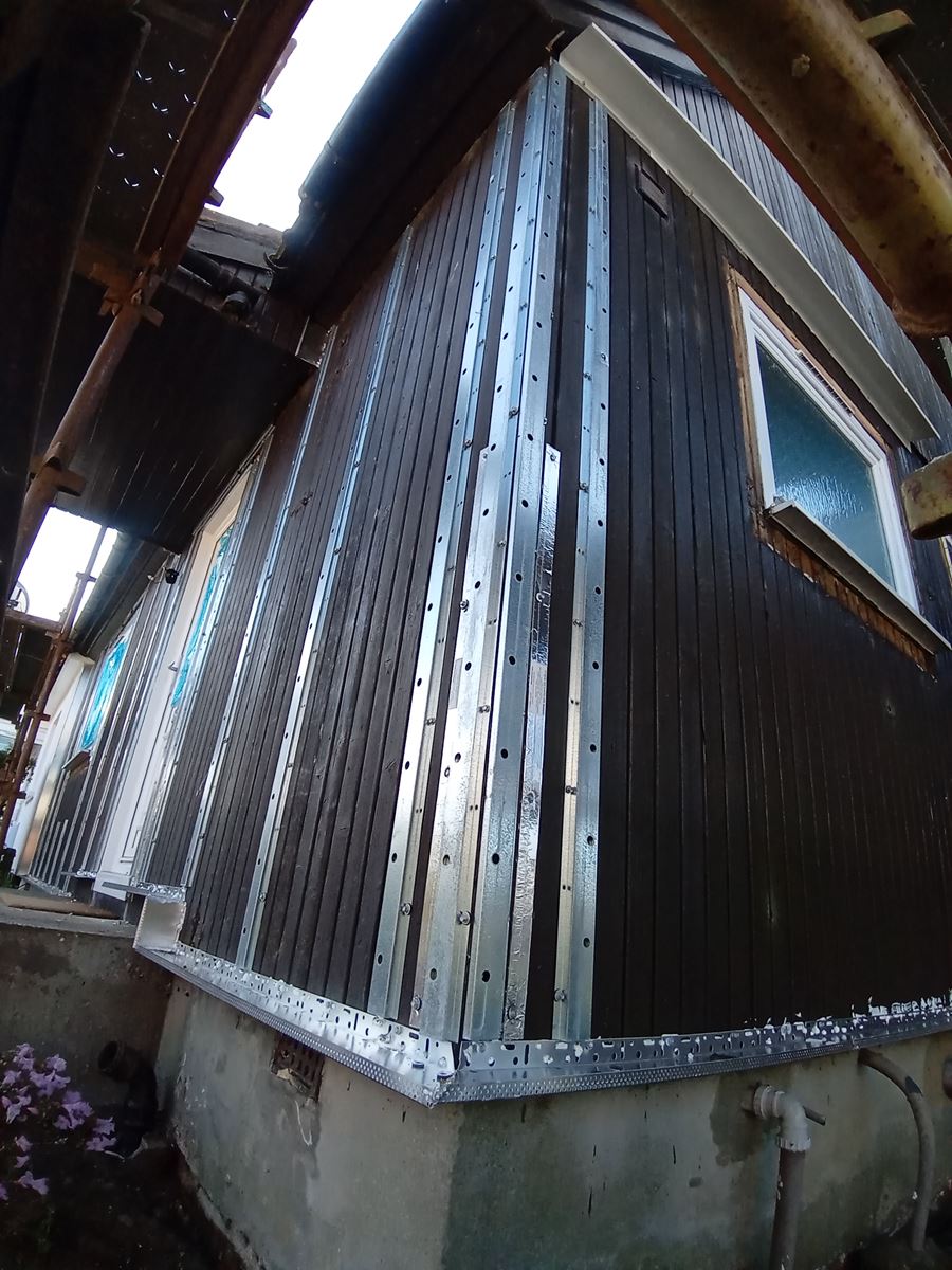 Rendering Edinburgh on exterior wall with timber cladding strips