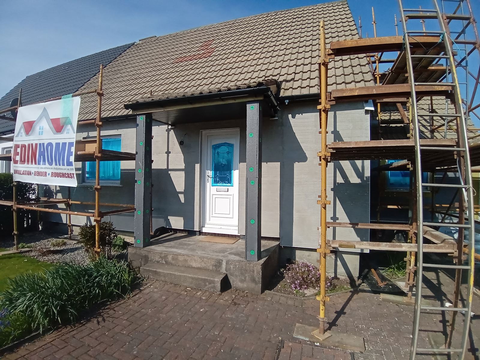 roughcast repair on porch entrance wall with blue protective film