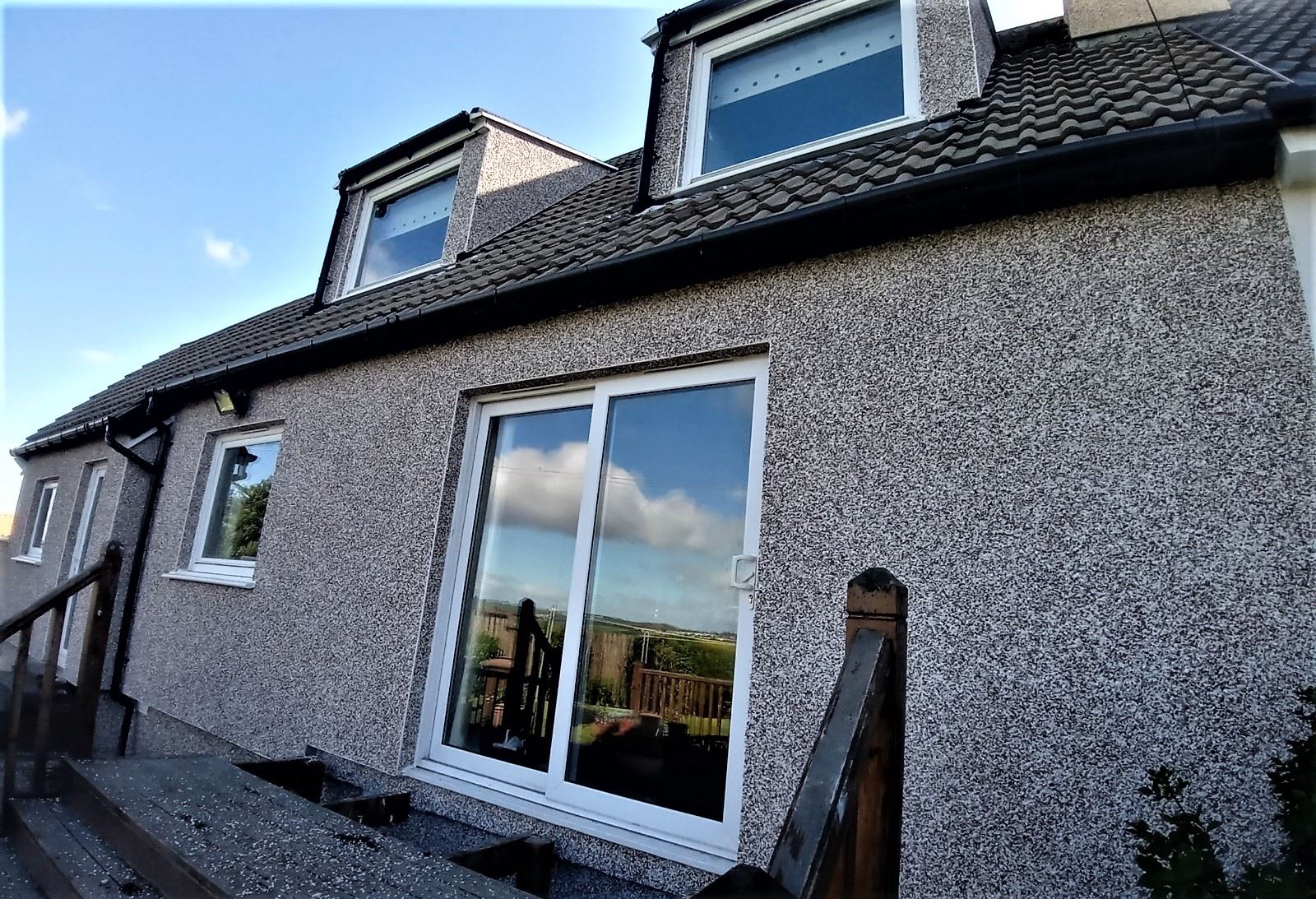 house rendering Edinburgh on rear wall with wide patio glass doors