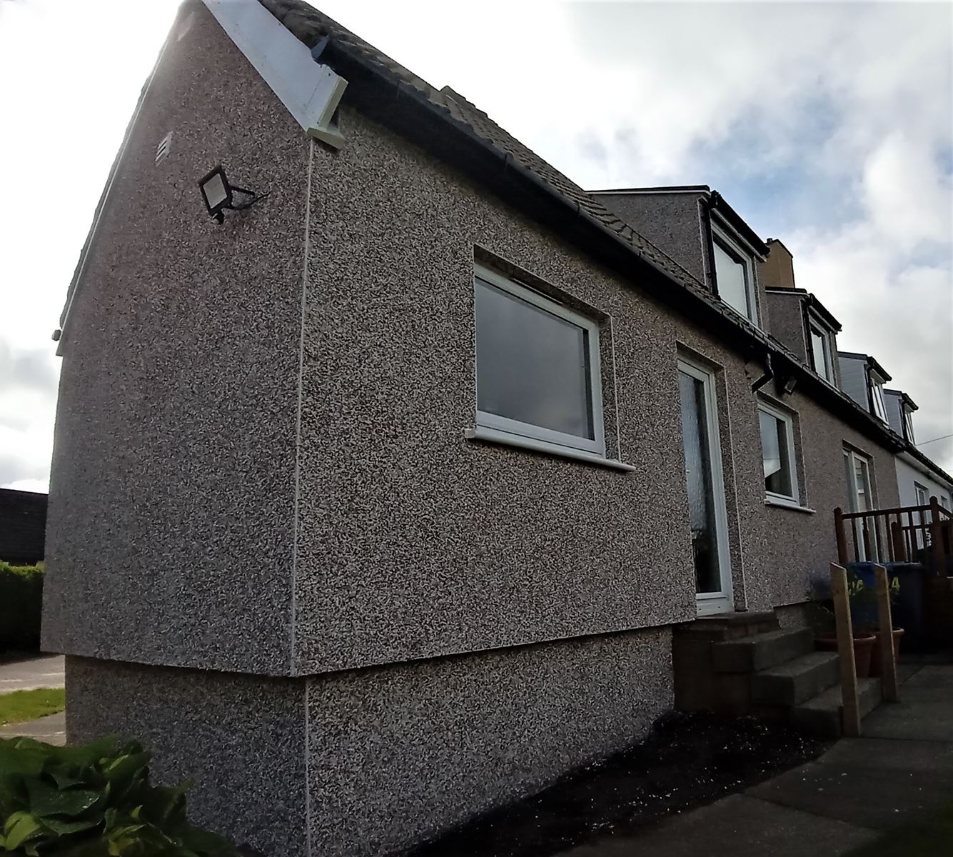 roughcast repair on house side wall with pebble dash finish