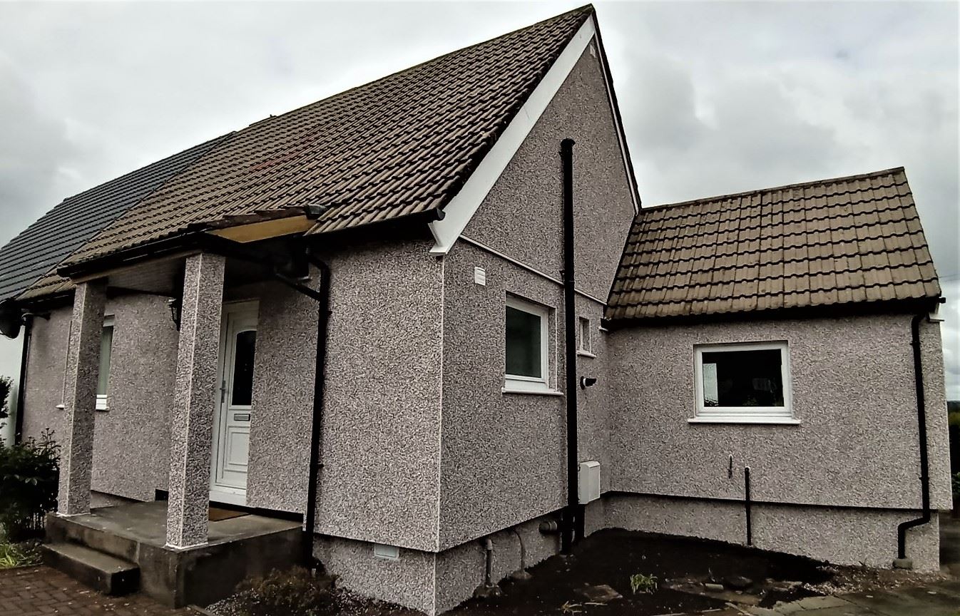 roughcast render repair on corner elevation with entrance door