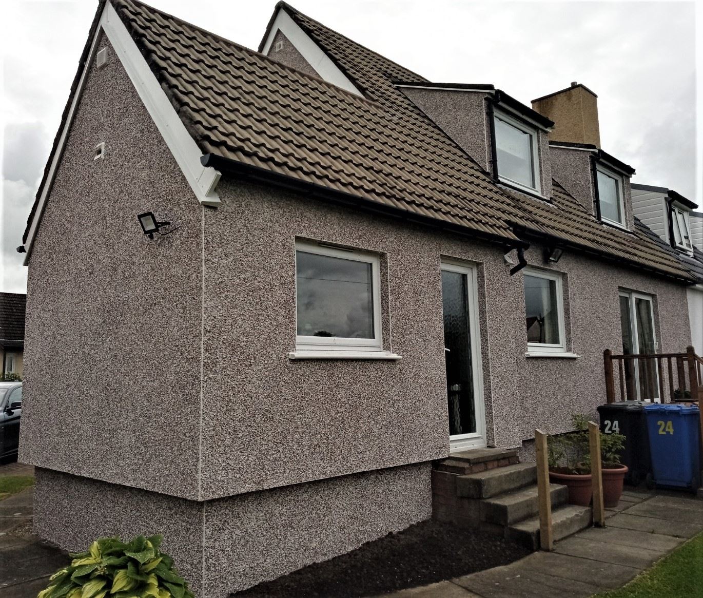 roughcast render repair on rear wall of property with grey finish