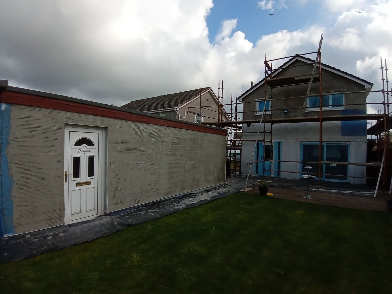 house rendering Edinburgh on garden-facing wall near lawn