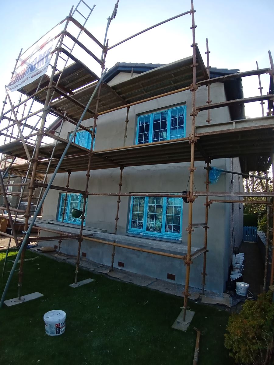external wall insulation Edinburgh being applied on rear façade with banner