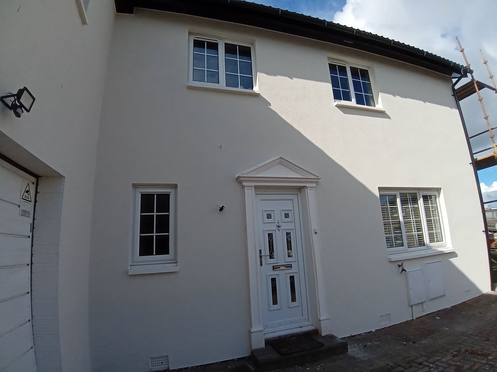 roughcast repair on main façade with detailed front doorway