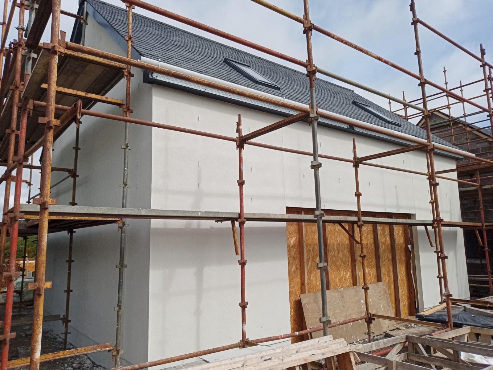 Insulation Edinburgh installed beneath fresh render under scaffolding