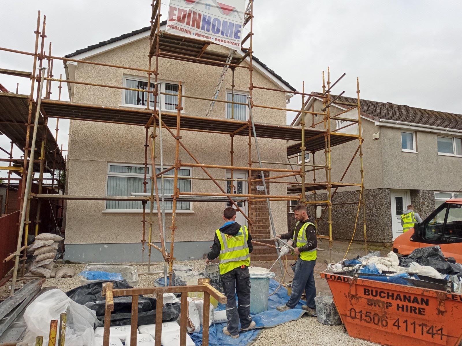 roughcast render Edinburgh renovation with scaffolding and workers
