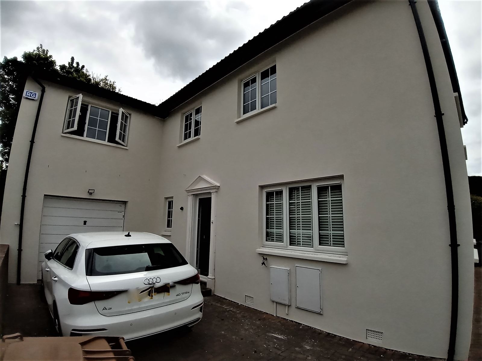 roughcast render Edinburgh on corner elevation with driveway and car